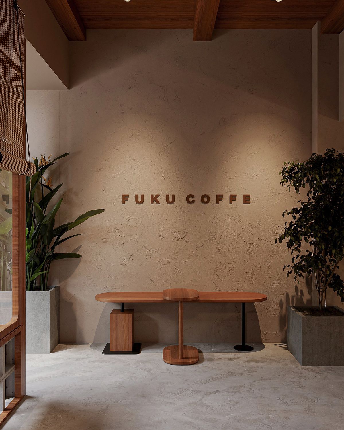 Inside Fuku Coffee: a hand-troweled plaster wall with small wooden FUKU COFFEE lettering, a sculptural teak table and stool beneath it, and tall potted plants at either side.